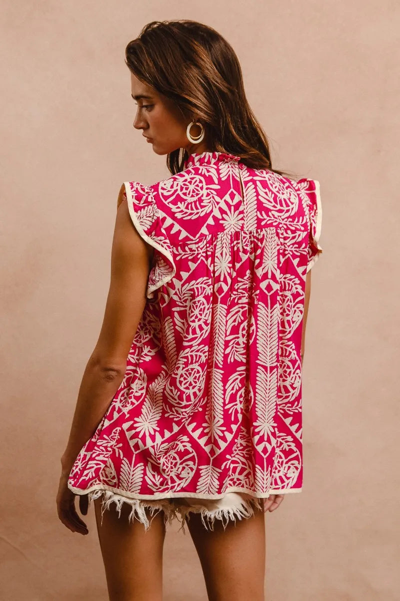 Woman wearing a pink and white patterned dress against a beige background