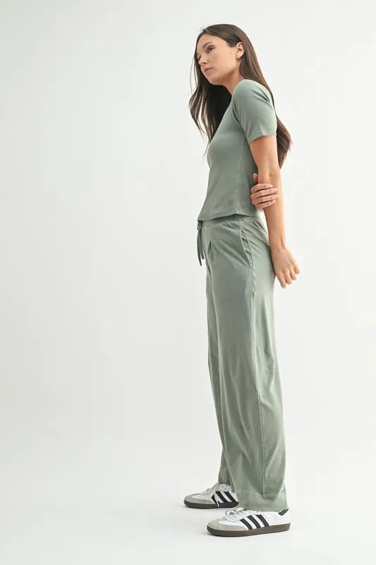 Woman wearing green lounge pants with matching top