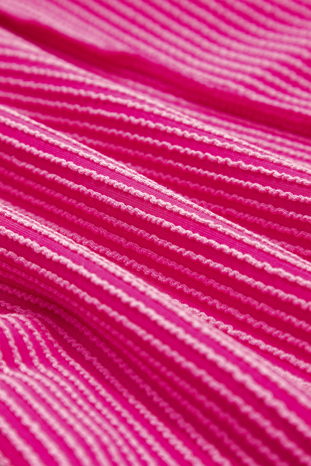 Close-up of pink fabric with a textured pattern