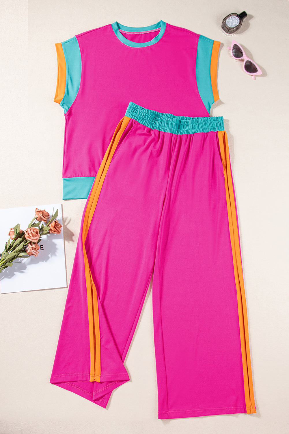 Pink outfit with colorful accents on a light background
