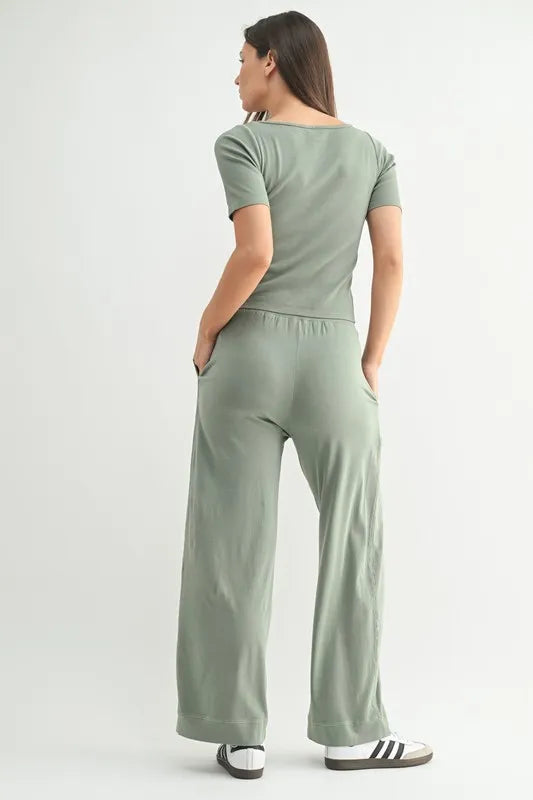 woman wearing green lounge pants with matching top