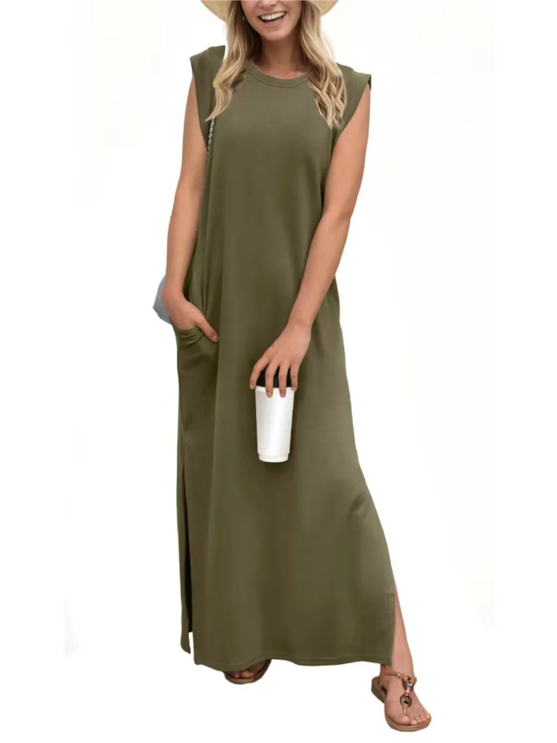 Woman wearing an olive green dress holding a white cup on a white background