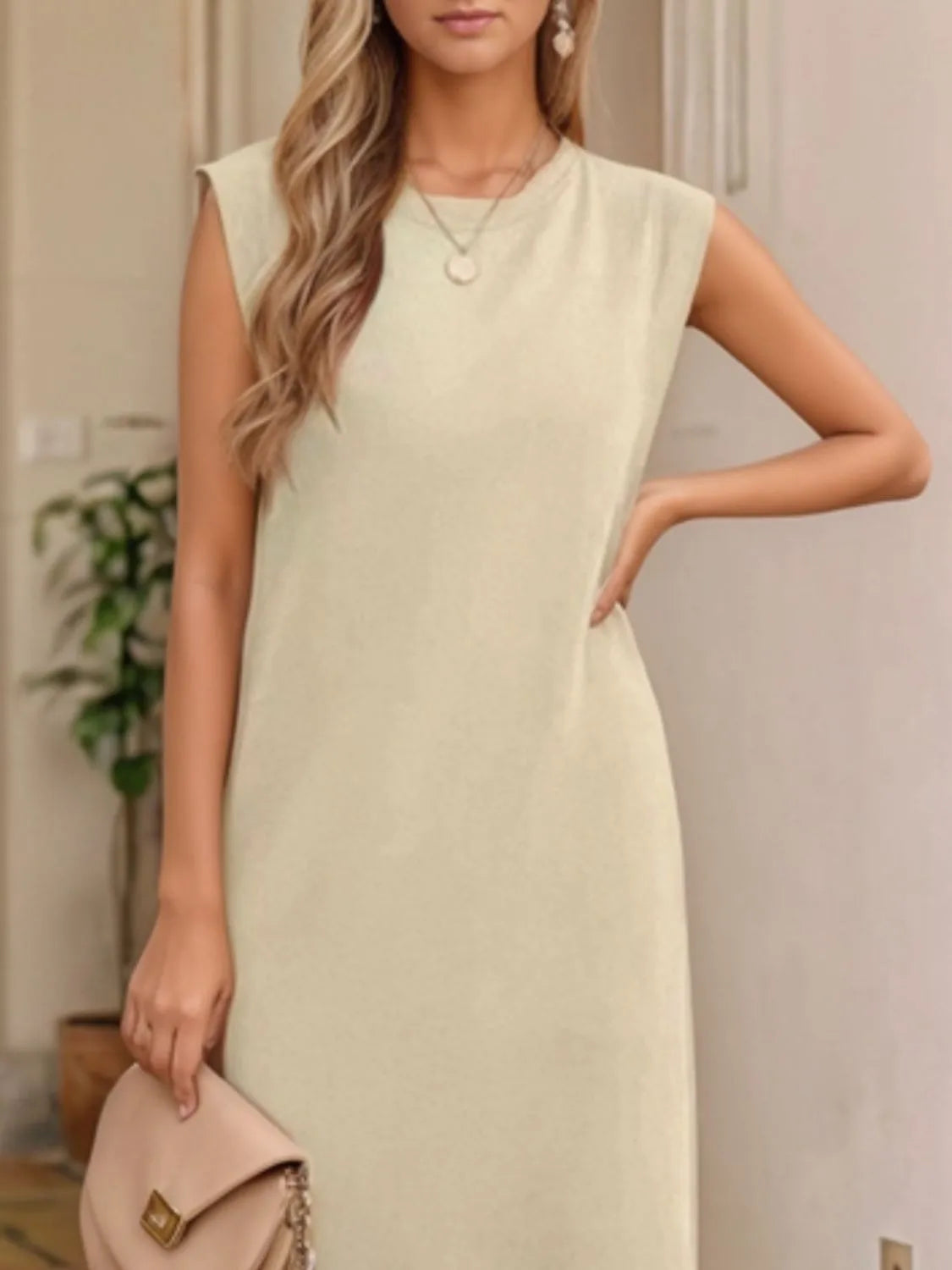 Woman wearing a light green dress with a neutral background