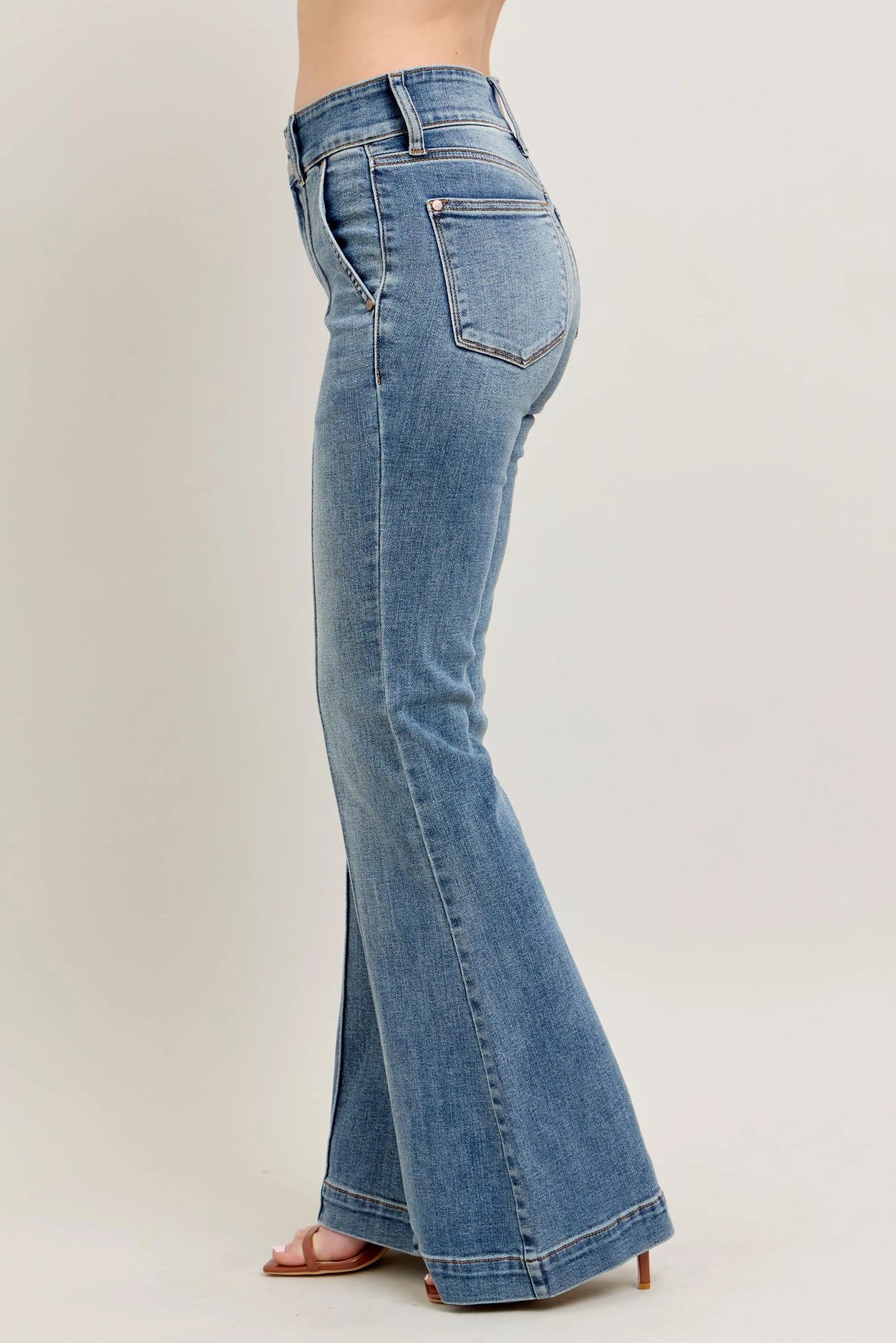 Blue flared jeans on a plain background