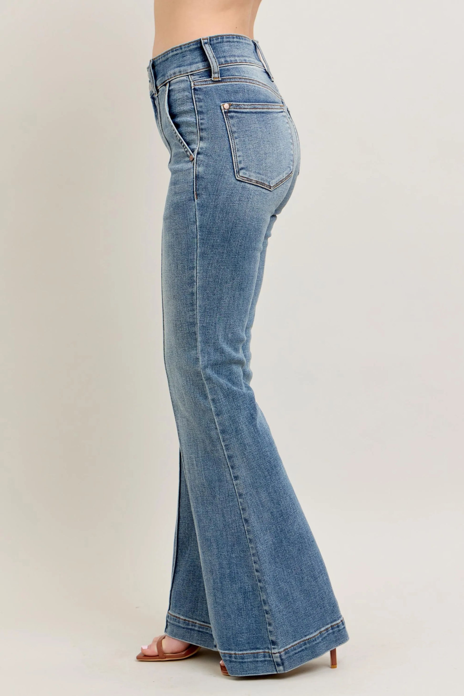 Blue flared jeans on a plain background