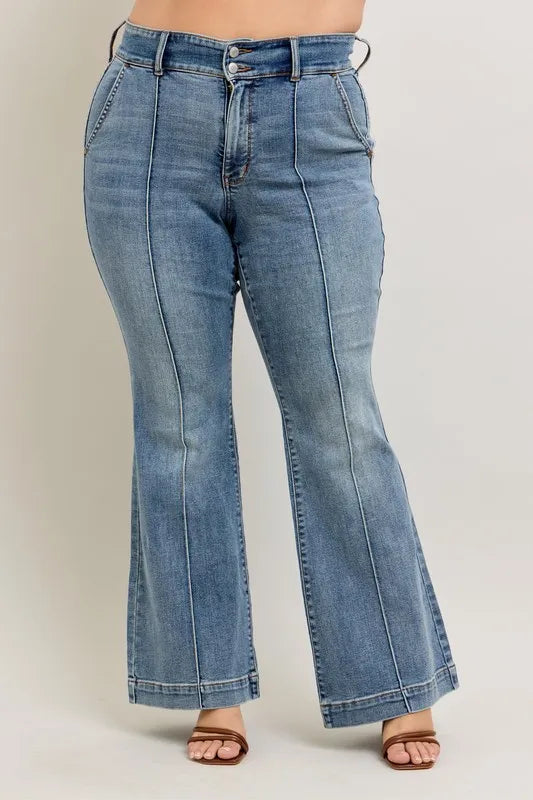 Blue flared jeans on a plain background