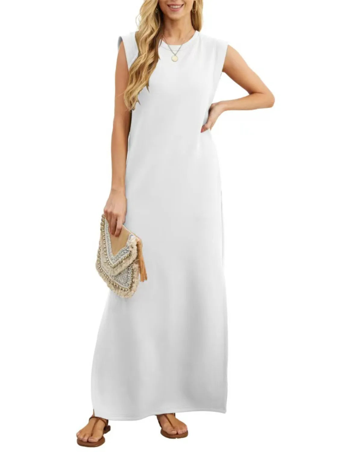 Woman wearing a white sleeveless dress holding a clutch on a white background