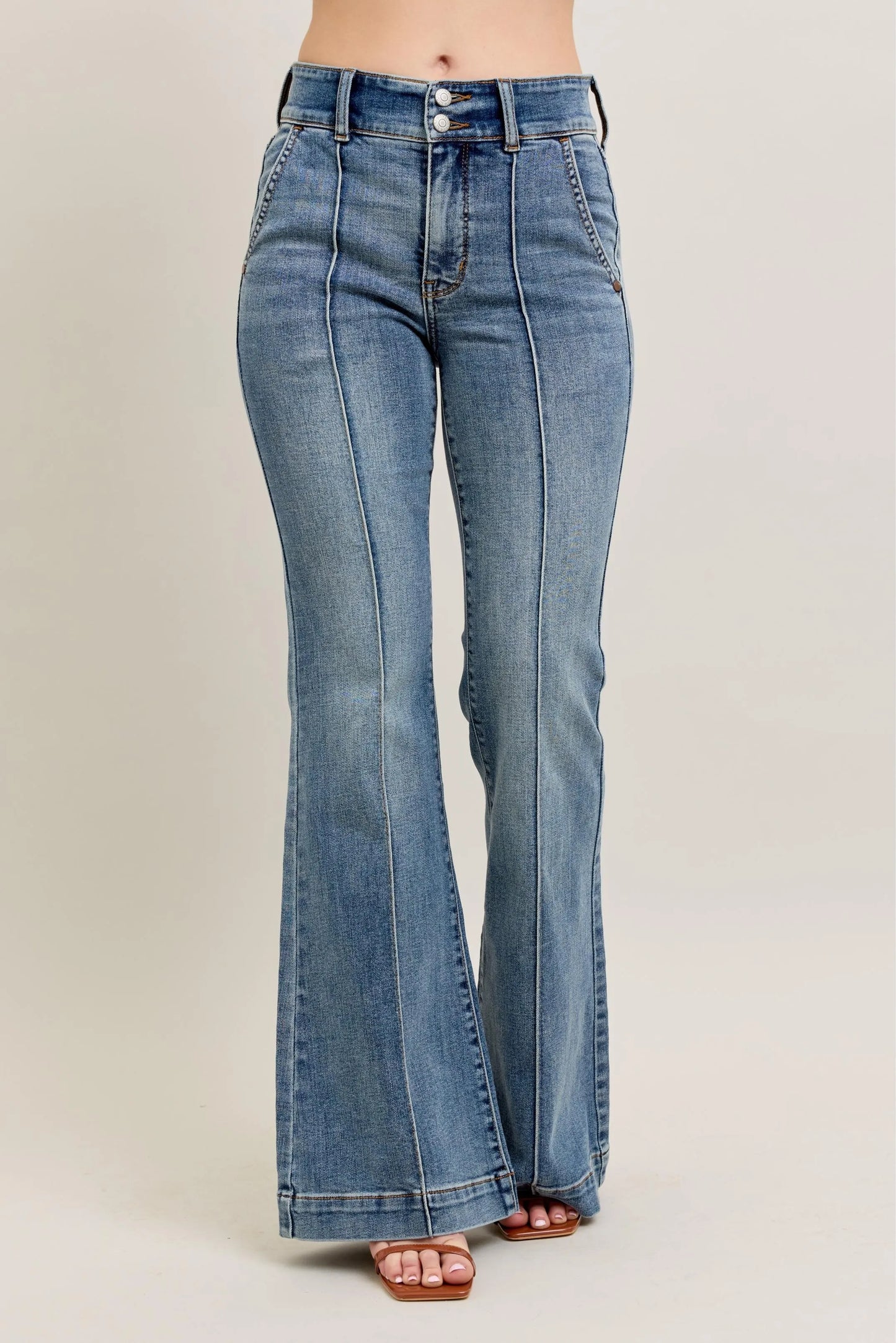 Blue flared jeans on a plain background