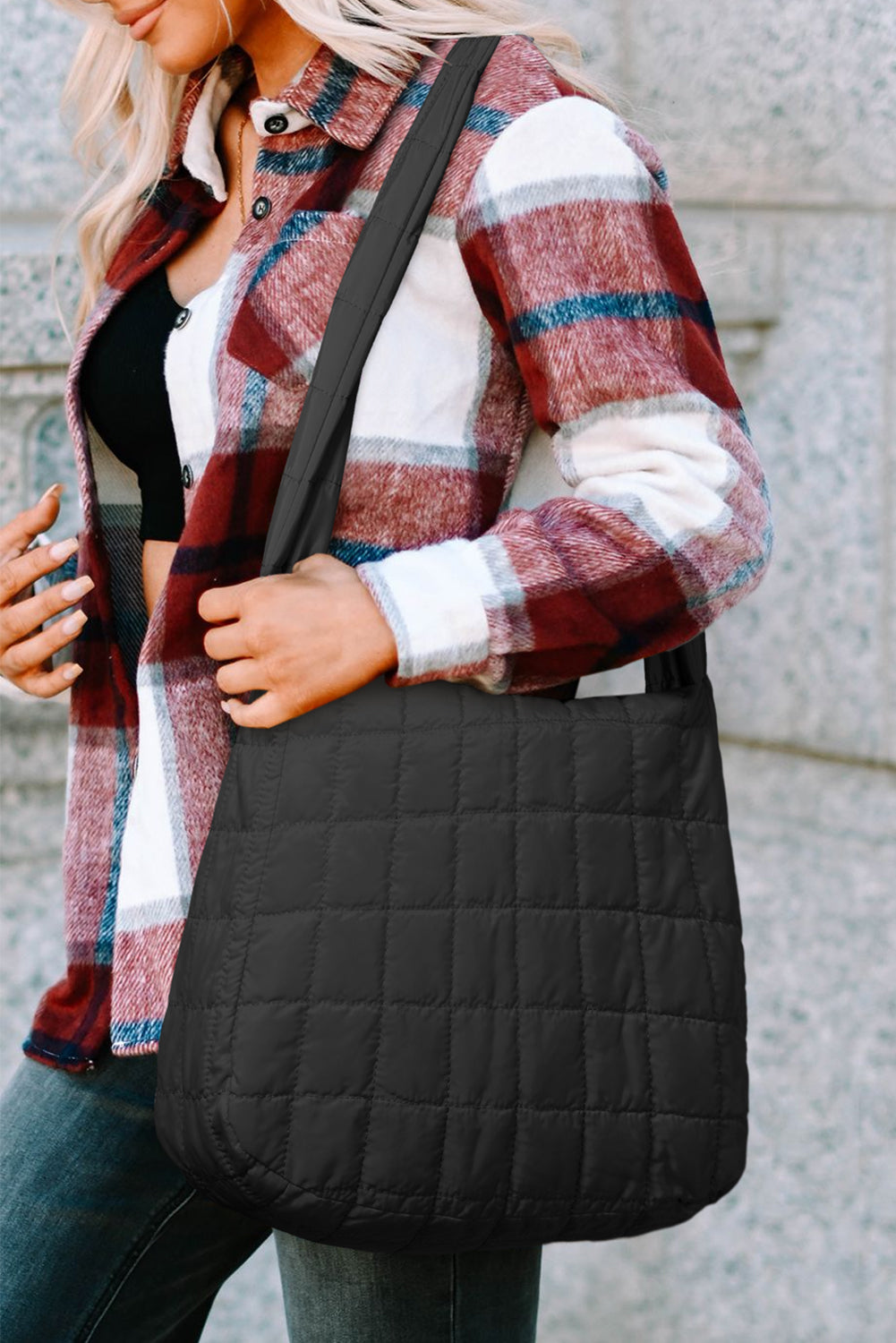Person with a black quilted bag