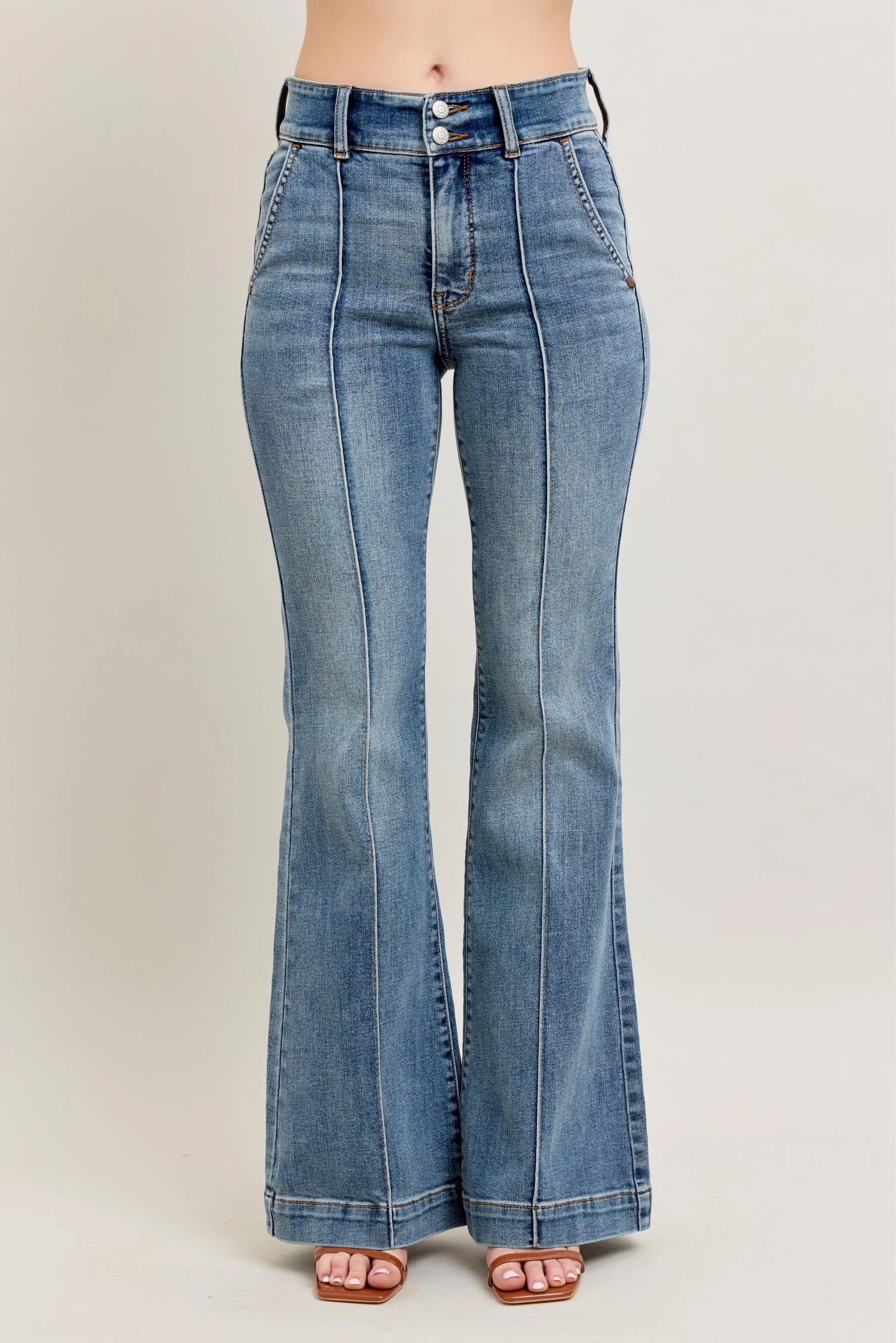 Blue flared jeans on a plain background