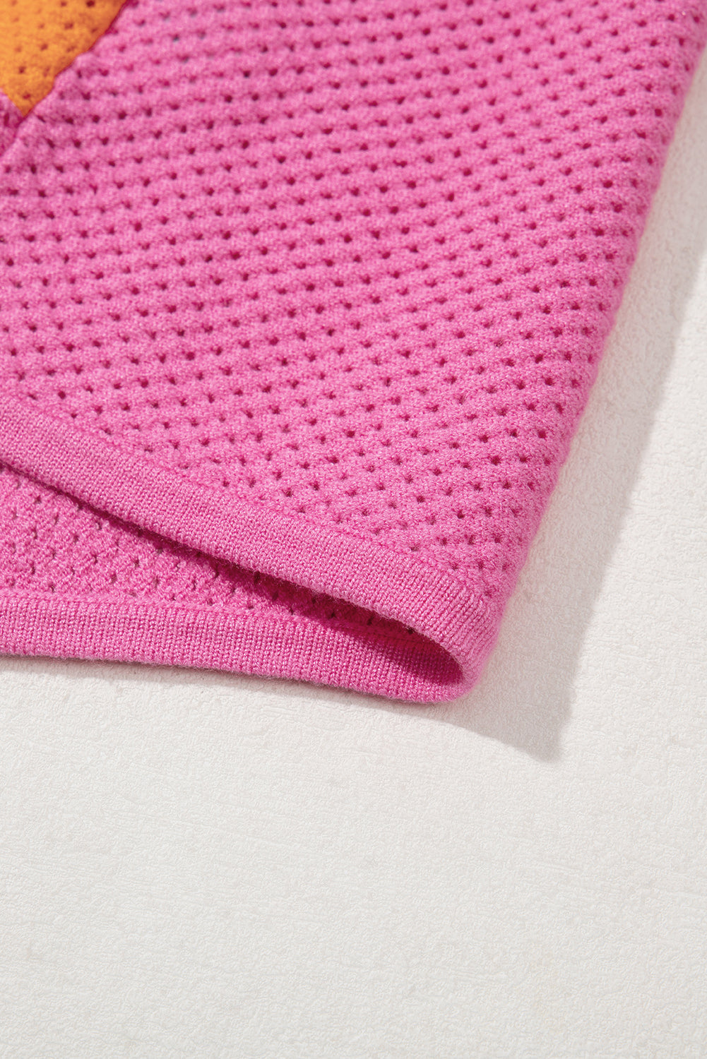 Close-up of a pink textured fabric on a white background