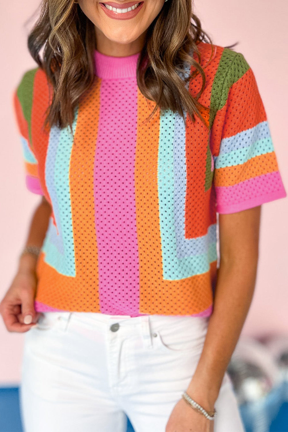 Person wearing a colorful striped shirt with a blurred background
