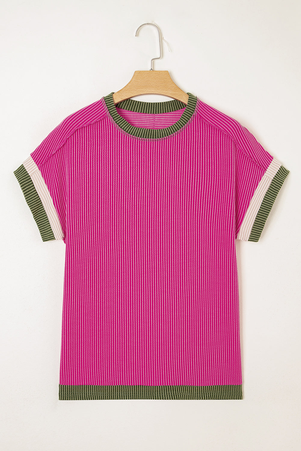 Pink striped shirt with green and white trim on a hanger against a white background