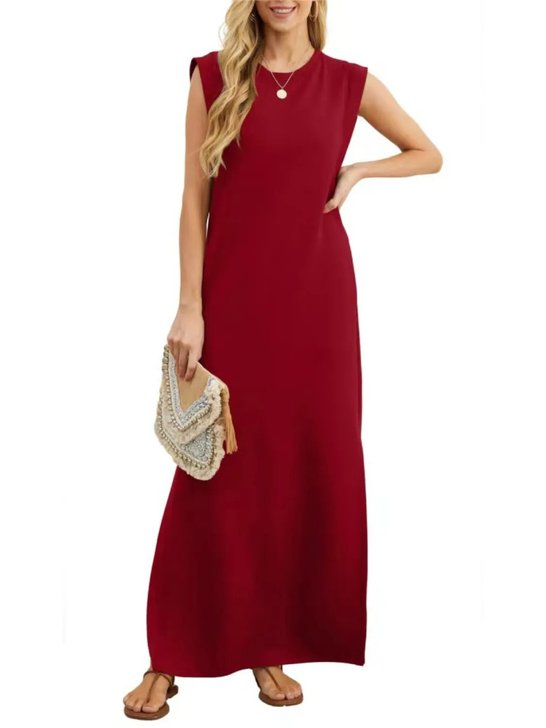 Woman wearing a red dress holding a beige handbag on a white background