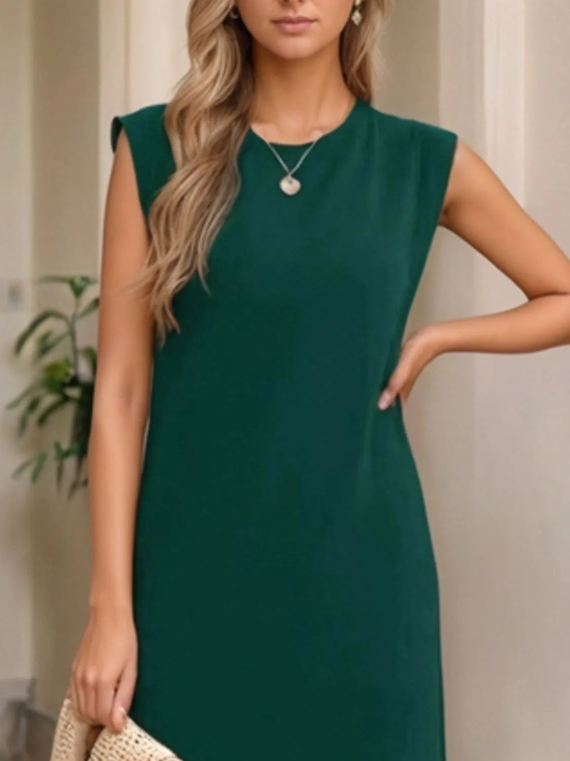 Woman wearing a green dress with a neutral background